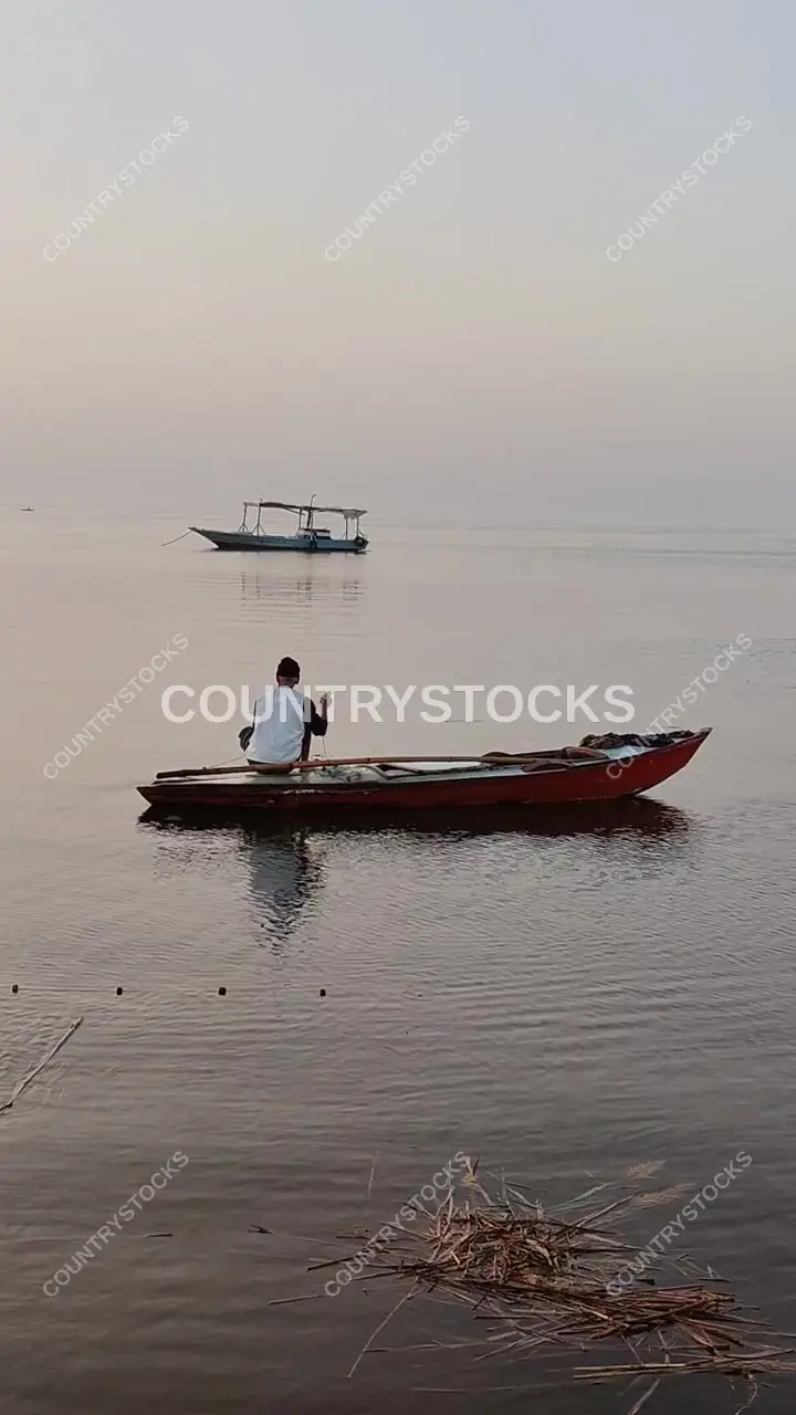 Fisherman in Wooden Boat, Lake Burullus at Dawn
