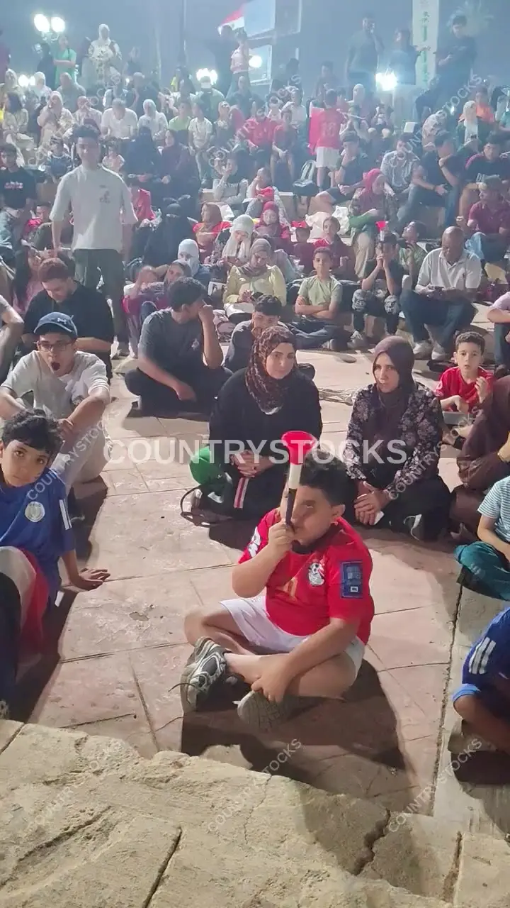 Young Egyptian Fan Blowing Vuvuzela at Night Match