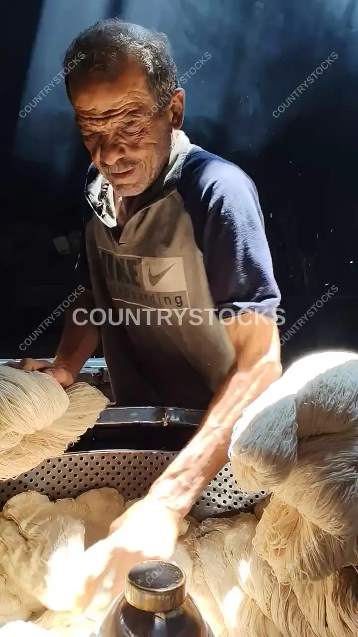 حرفي يجهز خيوط الغزل في مصبغة عم سلامة بالدرب الأحمر