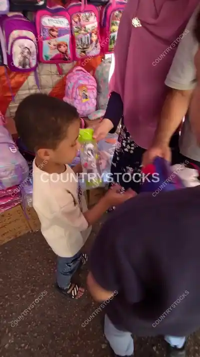 Child Choosing School Supplies at Cairo Street Vendor