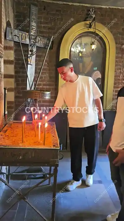 Visitor Lighting Candles at Mar Girgis Church Cairo